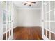 Empty office featuring hardwood flooring, crown moulding, and framed french doors at 364 Springtime Fields Ln, Wake Forest, NC 27587