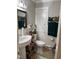Bathroom featuring pedestal sink, white tile, and organized storage at 405 Taylor Dr, Rocky Mount, NC 27803