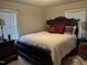 Comfortable bedroom featuring a decorative wood bed frame, white comforter, and matching furniture at 405 Taylor Dr, Rocky Mount, NC 27803