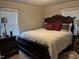 Comfortable bedroom featuring a decorative wood bed frame, white comforter, and matching furniture at 405 Taylor Dr, Rocky Mount, NC 27803