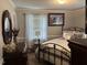 Cozy bedroom with a wrought iron bed, decorative pillows, and a window at 405 Taylor Dr, Rocky Mount, NC 27803