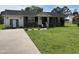 Charming brick and vinyl sided single story home with a well-manicured front yard and inviting entrance at 405 Taylor Dr, Rocky Mount, NC 27803
