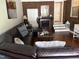 Inviting living room showcases a decorative fireplace, rich brick wall, and plush leather sectional at 405 Taylor Dr, Rocky Mount, NC 27803