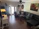 Comfortable living room features hardwood floors, large leather sofa, and ample natural light at 405 Taylor Dr, Rocky Mount, NC 27803