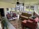 Inviting sunroom featuring comfortable seating, ceiling fans, and abundant natural light from large windows at 405 Taylor Dr, Rocky Mount, NC 27803