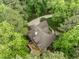 Aerial view of the home with an outdoor deck set amongst a lush, green neighborhood at 406 Bakewell Ct, Wake Forest, NC 27587