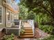 Wooden deck with dining area and grill, as well as stairs leading down into the backyard at 406 Bakewell Ct, Wake Forest, NC 27587
