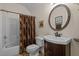 Neutral bathroom featuring a dark wood vanity and a shower with a patterned curtain at 406 Bakewell Ct, Wake Forest, NC 27587