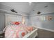 Bright bedroom with white headboard and ceiling fan at 406 Bakewell Ct, Wake Forest, NC 27587