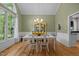 Traditional dining room with hardwood floors, white wainscoting, and a built-in hutch at 406 Bakewell Ct, Wake Forest, NC 27587