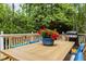 Close up of dining table with seating for four, and a built in grill on the back deck at 406 Bakewell Ct, Wake Forest, NC 27587
