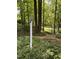 Lush landscaping features an ornamental lamp post with a birdhouse on top in a backyard setting at 406 Bakewell Ct, Wake Forest, NC 27587