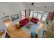 Bright and airy living room with a stone fireplace, hardwood floors, and comfortable red furniture at 406 Bakewell Ct, Wake Forest, NC 27587