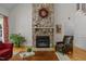 Inviting living room with a floor-to-ceiling stone fireplace, hardwood floors, and a leather armchair at 406 Bakewell Ct, Wake Forest, NC 27587