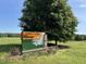 The E. Carroll Joyner Park sign stands near a green lawn and tree, under a blue sky at 406 Bakewell Ct, Wake Forest, NC 27587