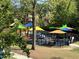 Colorful playground featuring slides, climbing structures and swings in Holding Park at 406 Bakewell Ct, Wake Forest, NC 27587
