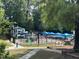 A sunny view of the water park with slides, splash pad and pool at Holding Park at 406 Bakewell Ct, Wake Forest, NC 27587
