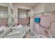 Pink bathroom with a sink, toilet, tub and shelving at 424 Raleigh View Rd, Raleigh, NC 27610
