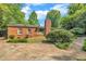 Brick exterior with mature landscaping and ample parking space at 424 Raleigh View Rd, Raleigh, NC 27610