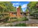 Charming brick home featuring a bird bath, bird feeder, chimney and mature trees at 424 Raleigh View Rd, Raleigh, NC 27610