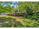 Brick home with mature trees, a covered entrance, a wheelchair ramp and a walkway leading to the front door at 424 Raleigh View Rd, Raleigh, NC 27610