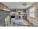 Cluttered kitchen with outdated cabinets, appliances, and various items scattered throughout at 424 Raleigh View Rd, Raleigh, NC 27610