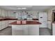 Bright kitchen with island, ample cabinetry, and stainless steel refrigerator at 424 Raleigh View Rd, Raleigh, NC 27610