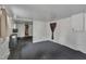 Living room with white walls, dark carpet, an access door, and a window providing natural light at 424 Raleigh View Rd, Raleigh, NC 27610