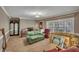 Cozy living room with natural light from the bay window with shutters at 424 Raleigh View Rd, Raleigh, NC 27610