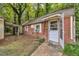 Brick exterior featuring a side door entrance, windows, and adjacent storage shed at 424 Raleigh View Rd, Raleigh, NC 27610