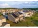 Aerial view of houses with solar panels on roofs in a neighborhood with manicured lawns at 428 Parlier Dr, Apex, NC 27523