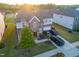 Aerial view of a house with solar panels and cars parked in the driveway at 428 Parlier Dr, Apex, NC 27523