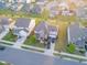 Aerial view of a residential neighborhood showcasing a home with a well-manicured lawn and multiple parked vehicles at 428 Parlier Dr, Apex, NC 27523