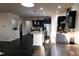 Modern kitchen boasting sleek black cabinetry, stainless steel appliances, an island with granite countertops, and hardwood floors at 428 Parlier Dr, Apex, NC 27523