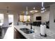 Modern kitchen featuring a granite countertop island with a sink and stainless steel appliances overlooking the living area at 428 Parlier Dr, Apex, NC 27523