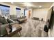 Cozy living room with plush gray sectional, wooden coffee tables, and large windows for natural light at 428 Parlier Dr, Apex, NC 27523