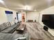 Spacious living room with a large sectional couch, carpet, and a wall-mounted TV at 428 Parlier Dr, Apex, NC 27523