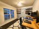 Home office with a large window, gray accent wall, and shelving at 428 Parlier Dr, Apex, NC 27523