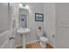 Bathroom featuring a pedestal sink, decorative mirror, and modern fixtures, offering a clean and functional design at 4306 Brynwood Ave, Durham, NC 27713