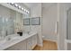 Well-lit bathroom with a double vanity, large mirror, and glass-enclosed shower providing a spa-like experience at 4306 Brynwood Ave, Durham, NC 27713