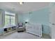 Cozy Bedroom with a crib, a comfortable chair, and a window offering natural light at 4306 Brynwood Ave, Durham, NC 27713