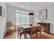 Inviting dining room featuring hardwood floors, a rustic wooden table, and ample natural light at 4306 Brynwood Ave, Durham, NC 27713