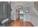 Bright foyer with hardwood floors, elegant wainscoting, and an arched entryway at 4306 Brynwood Ave, Durham, NC 27713