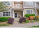 Inviting townhouse featuring lush landscaping and a charming covered entrance with seating at 4306 Brynwood Ave, Durham, NC 27713