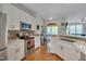 Bright kitchen featuring stainless appliances, quartz countertops, stylish hardware, and seamless flow to the living area at 4306 Brynwood Ave, Durham, NC 27713