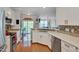 Bright kitchen featuring stainless appliances, quartz countertops, stylish hardware, and seamless flow to the living area at 4306 Brynwood Ave, Durham, NC 27713