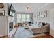 Cozy living room featuring a fireplace, plush sectional sofa, and ample natural light at 4306 Brynwood Ave, Durham, NC 27713