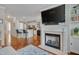 Open-concept living room featuring a fireplace, built-in shelves, and hardwood floors, creating a cozy and inviting atmosphere at 4306 Brynwood Ave, Durham, NC 27713