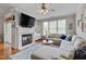 Inviting living room with a fireplace, built-in shelving, and comfortable sectional seating at 4306 Brynwood Ave, Durham, NC 27713