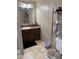 Bathroom with a single vanity, storage shelving, and neutral wall colors at 4855 Mike Ln, Nashville, NC 27856